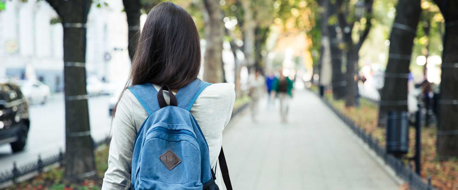 Image of a college student walking away from the camera